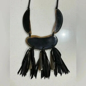 Tribal-inspired necklace made of buffalo horn and leather tassels